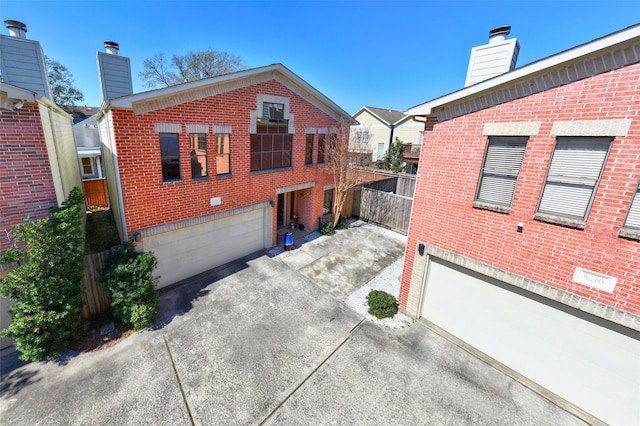 exterior space featuring a chimney and brick siding