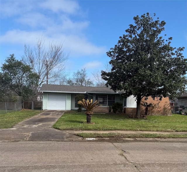 view of front of home featuring a garage, fence, a front lawn, and concrete driveway