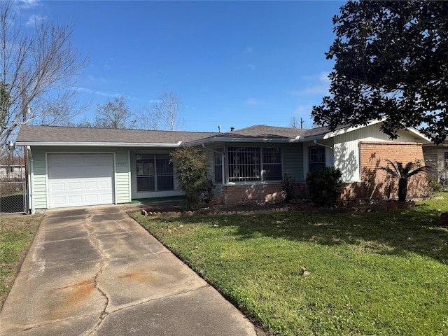 ranch-style home featuring a garage, brick siding, concrete driveway, and a front yard