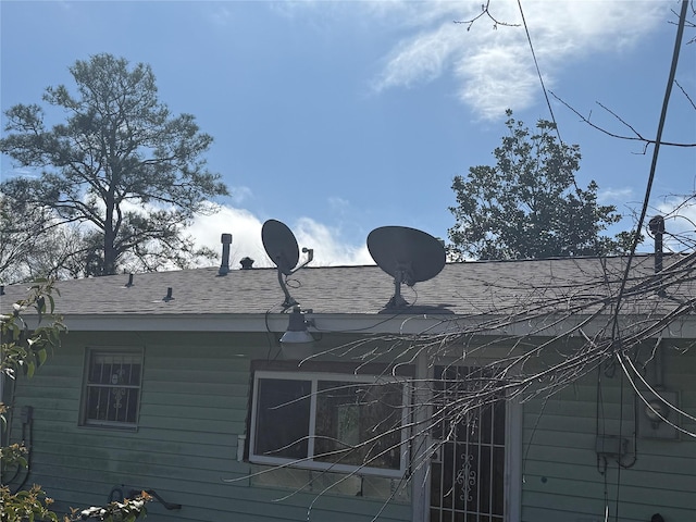 exterior space with a shingled roof