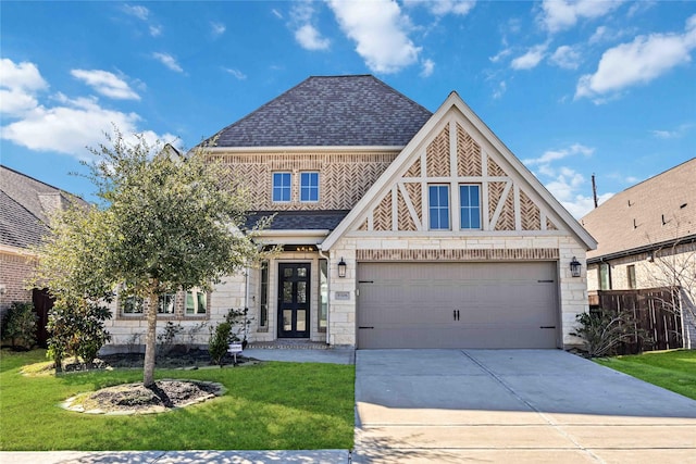 view of front of home with a shingled roof, concrete driveway, a garage, stone siding, and a front lawn