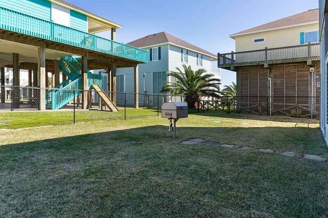 view of yard featuring fence and stairway