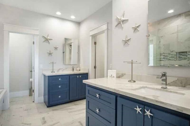 full bath with marble finish floor, recessed lighting, two vanities, a stall shower, and a sink