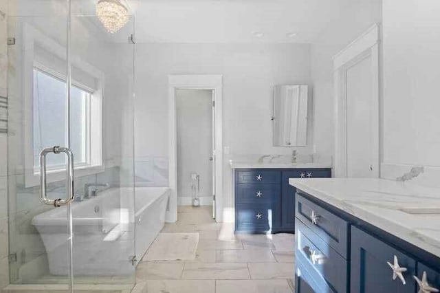 full bath with a stall shower, a soaking tub, and vanity