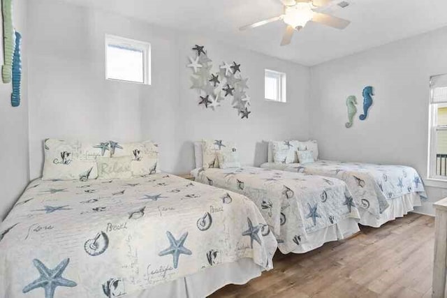 bedroom with a ceiling fan and wood finished floors