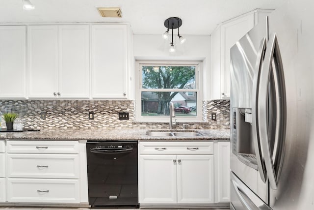 kitchen featuring black dishwasher, visible vents, a sink, stainless steel refrigerator with ice dispenser, and backsplash