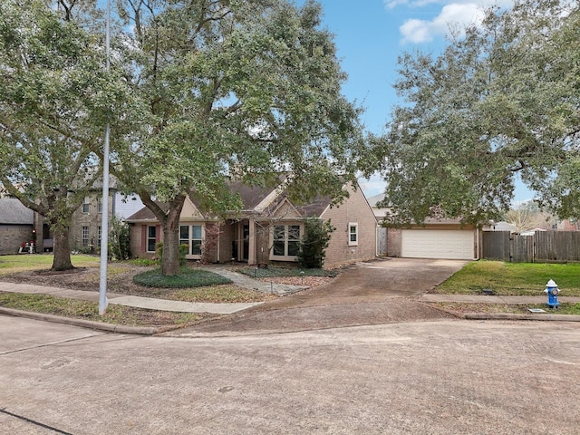 view of front facade featuring a front yard, fence, and brick siding