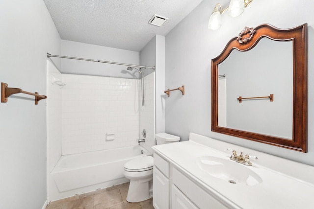 bathroom featuring visible vents, toilet, vanity, a textured ceiling, and tile patterned floors