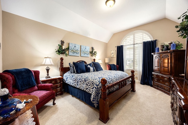 bedroom featuring lofted ceiling and light colored carpet