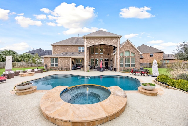 view of pool with a patio area, fence, a fenced in pool, and an in ground hot tub