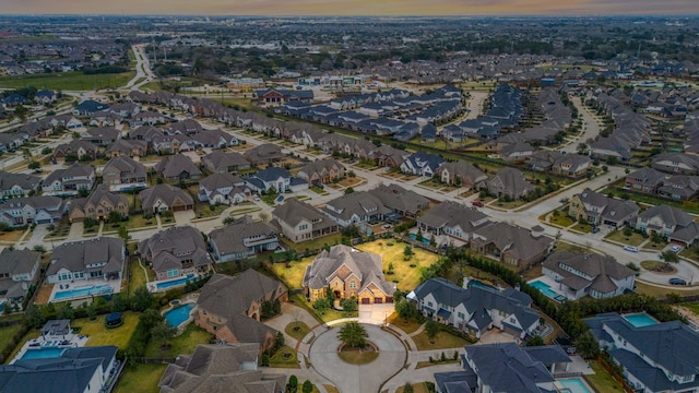 aerial view at dusk featuring a residential view