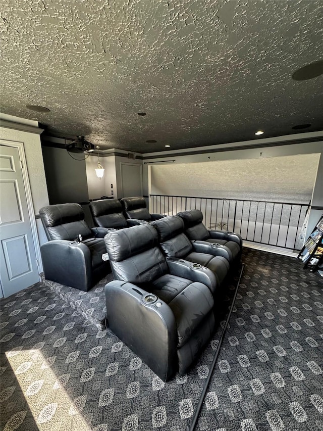 home theater room with dark carpet and a textured ceiling