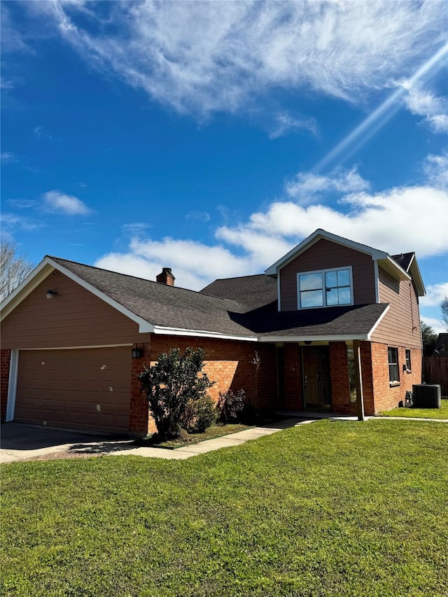 traditional home featuring concrete driveway, a chimney, an attached garage, a front lawn, and brick siding