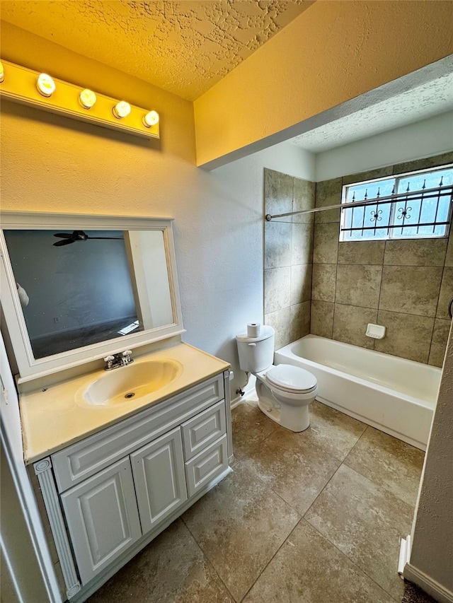 full bathroom featuring tub / shower combination, toilet, a textured ceiling, and vanity