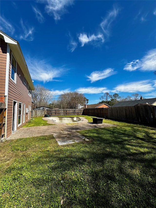 view of yard featuring a patio area and a fenced backyard