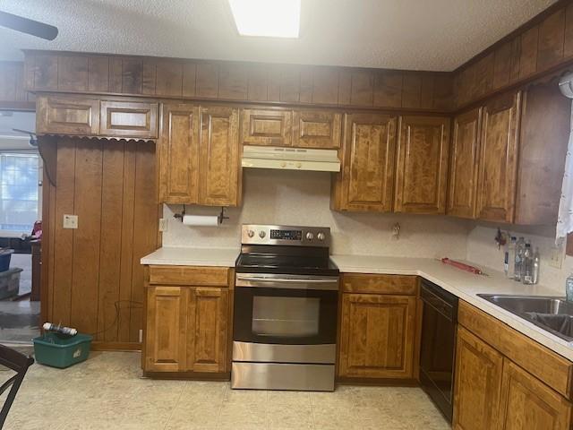 kitchen featuring under cabinet range hood, electric range, black dishwasher, light countertops, and brown cabinetry