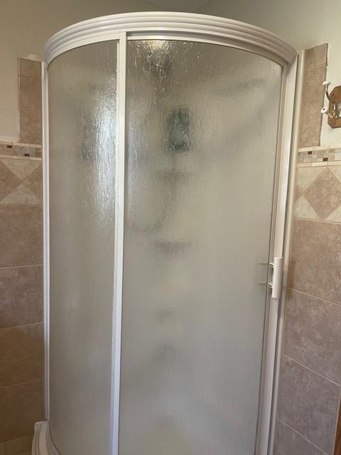 full bathroom featuring a stall shower