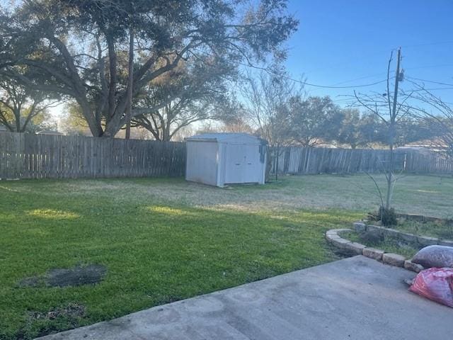 view of yard with a storage shed, a patio, an outdoor structure, and a fenced backyard