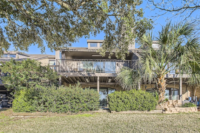 rear view of house with a yard