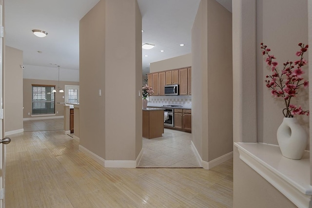 hall featuring light wood-style floors, recessed lighting, and baseboards