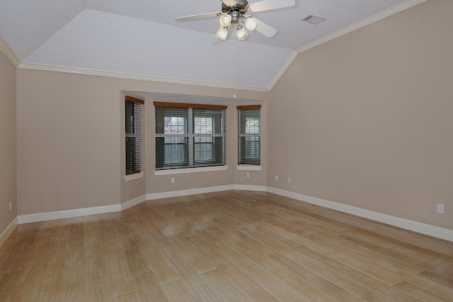 unfurnished room featuring visible vents, baseboards, vaulted ceiling, light wood-type flooring, and crown molding