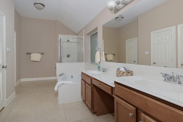 bathroom with a stall shower, tile patterned flooring, a garden tub, and a sink