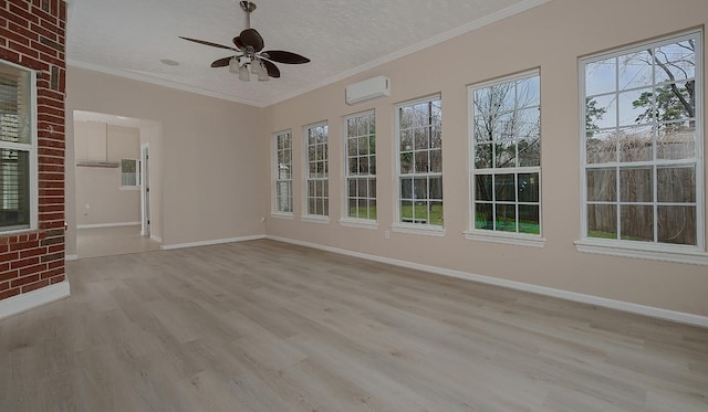 unfurnished sunroom with a ceiling fan and a wall mounted air conditioner