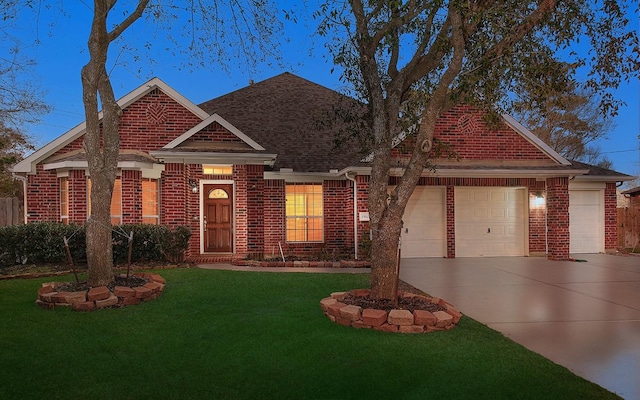 view of front of home with concrete driveway, brick siding, a front lawn, and an attached garage