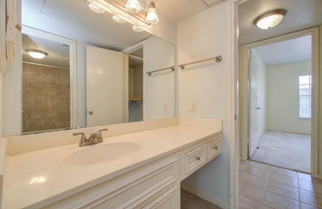 bathroom featuring tile patterned flooring, baseboards, and vanity