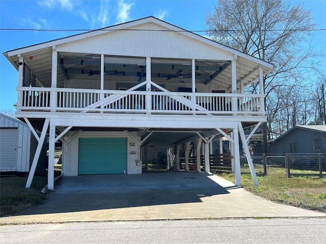 beach home featuring ceiling fan, a carport, and covered porch