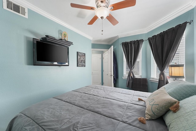 bedroom featuring a ceiling fan, visible vents, and crown molding