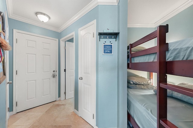 entrance foyer featuring light tile patterned floors, baseboards, and crown molding