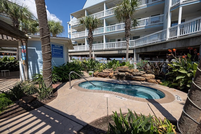 view of swimming pool with a community hot tub