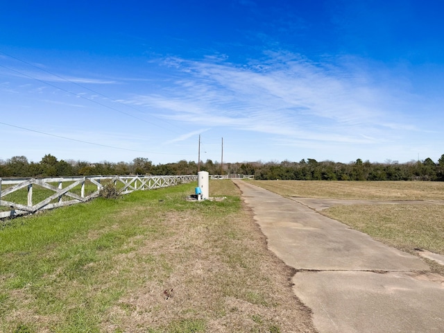 view of yard featuring a rural view and fence