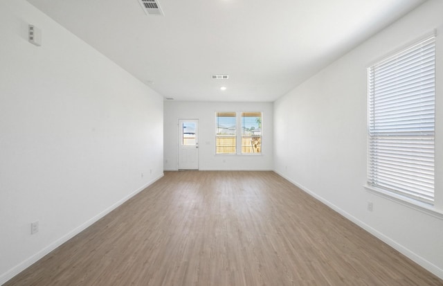 10702 Sora Dr, Willis, TX 77378 - unfurnished room featuring wood finished floors, visible vents, and baseboards