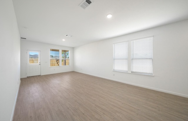 10702 Sora Dr, Willis, TX 77378 - empty room with recessed lighting, wood finished floors, visible vents, and baseboards