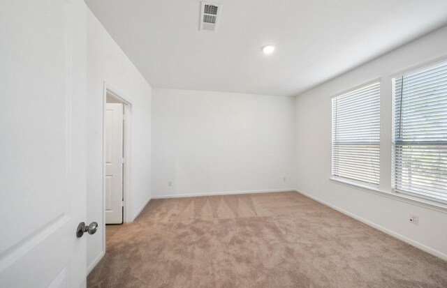 10702 Sora Dr, Willis, TX 77378 - empty room with visible vents, light colored carpet, and baseboards