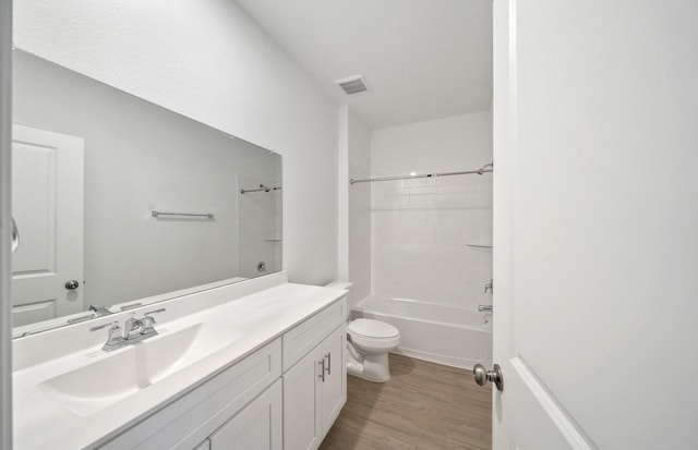 10702 Sora Dr, Willis, TX 77378 - full bath with vanity, wood finished floors, visible vents, bathing tub / shower combination, and toilet