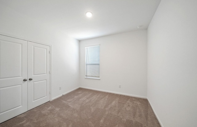 10702 Sora Dr, Willis, TX 77378 - unfurnished bedroom featuring a closet, baseboards, and carpet floors