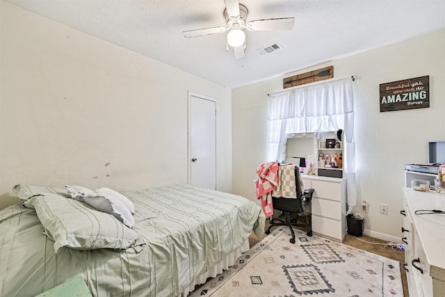 bedroom with ceiling fan, visible vents, and baseboards