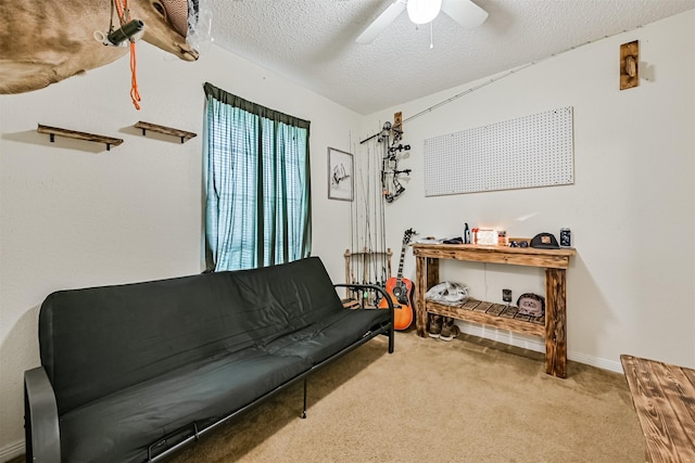 sitting room with light carpet, ceiling fan, a textured ceiling, and baseboards