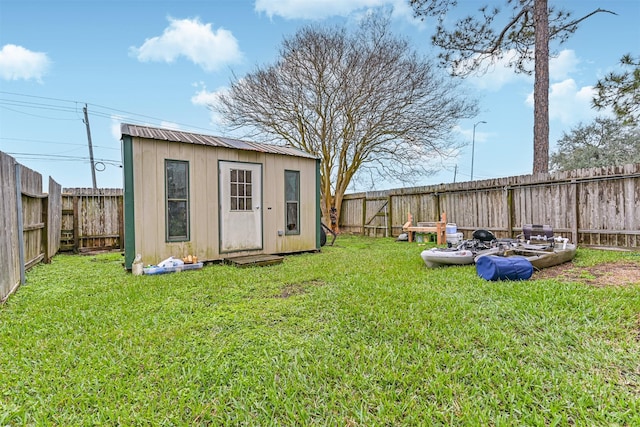 view of yard featuring a fenced backyard, an outdoor structure, and a storage shed