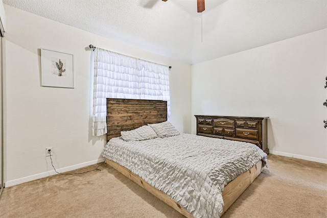 bedroom featuring baseboards, a textured ceiling, and light colored carpet