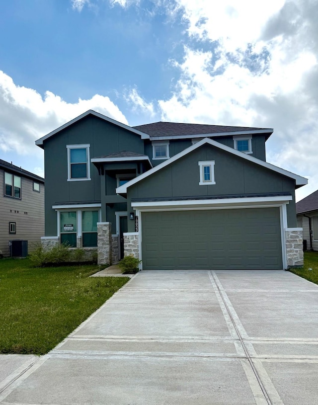 view of front facade with stone siding, a front yard, driveway, and central air condition unit