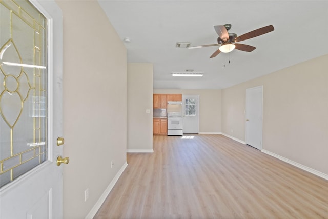 unfurnished living room with a ceiling fan, light wood-type flooring, visible vents, and baseboards