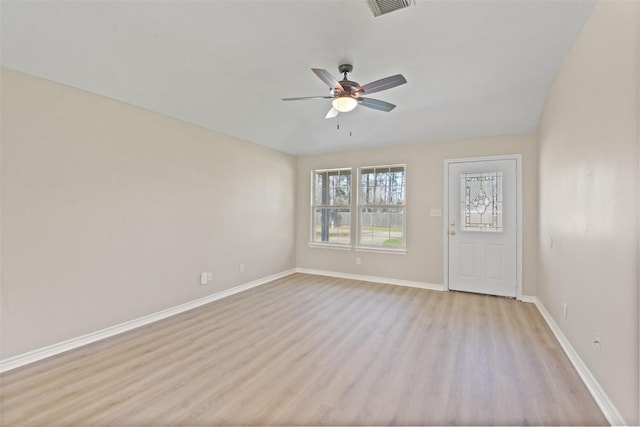 empty room featuring ceiling fan, light wood-type flooring, visible vents, and baseboards