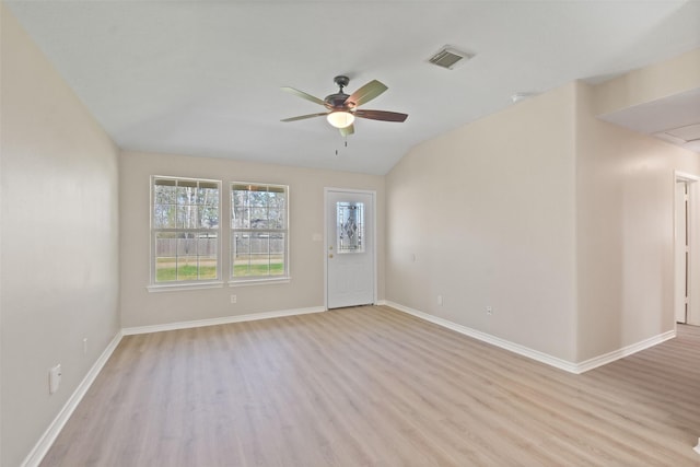 spare room featuring a ceiling fan, light wood-type flooring, visible vents, and baseboards