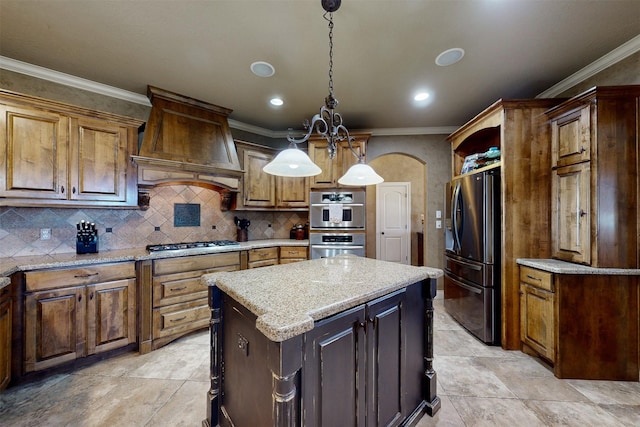 kitchen featuring arched walkways, a kitchen island, appliances with stainless steel finishes, custom exhaust hood, and decorative light fixtures