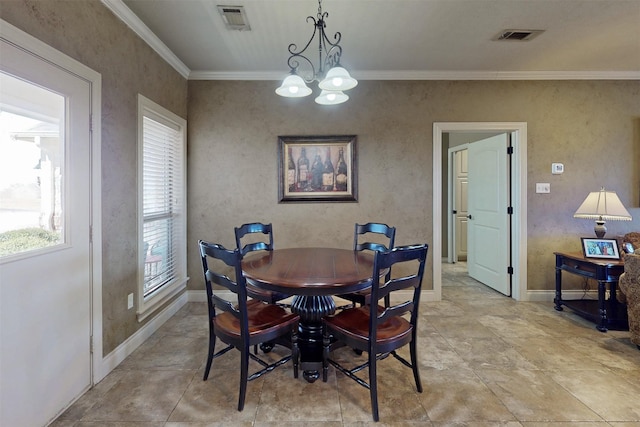 dining space with baseboards, visible vents, a chandelier, and ornamental molding