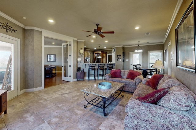 living area with recessed lighting, visible vents, baseboards, and ceiling fan with notable chandelier